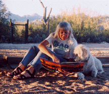 This is a photograph of Judi reading to her dog, Tessa.