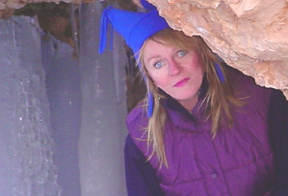This is a photo of Jackie peeking out of an ice cave in Bryce Canyon.