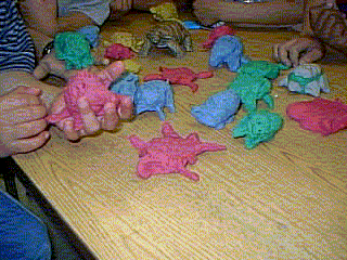 The photograph shows the students clay models of desert animals.