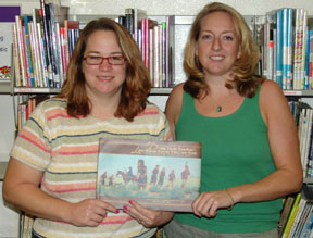 This is a photograph of Suzanne Brazzell and Carleen Young holding the book.