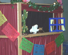 a mouse and a cockroach on a decorated puppet stage